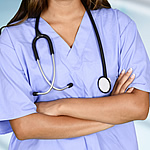 woman in purple scrubs with stethoscope